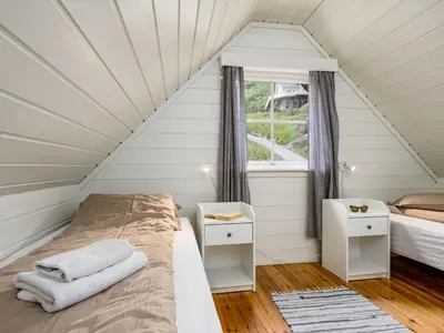 a bedroom with two beds and a window at Holiday Home Balder by Interhome in Arnefjord
