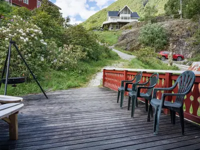 a group of chairs sitting on a wooden deck at Holiday Home Balder by Interhome in Arnefjord