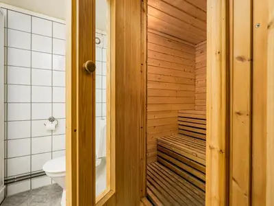 a wooden sauna with a toilet and a sink at Holiday Home Balder by Interhome in Arnefjord