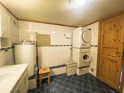a small bathroom with a washer and dryer in it at Holiday Home Naustet by Interhome in Sylte
