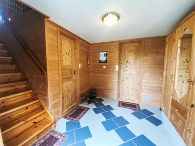 an empty room with wooden walls and blue tile floor at Holiday Home Naustet by Interhome in Sylte
