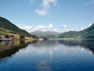 a large body of water with mountains in the background at Holiday Home Naustet by Interhome in Sylte