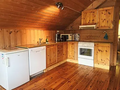 a kitchen with white appliances and wooden cabinets at Holiday Home Naustet by Interhome in Sylte