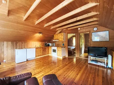 a large living room with wooden walls and wooden floors at Holiday Home Naustet by Interhome in Sylte