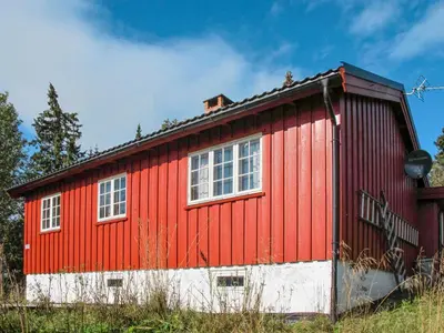 a red and white building with two windows at Chalet Skeisvegen by Interhome in Svingvoll