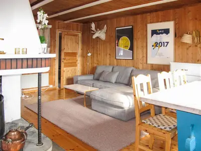 a living room with a couch and a table at Chalet Skeisvegen by Interhome in Svingvoll