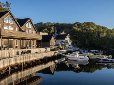 a boat is docked at a dock next to a house at Holiday Home Lange by Interhome in Bømlo