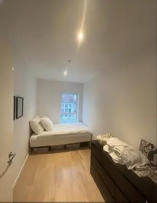 a room with two beds and a window at Moderne leilighet midt i hjertet av Bergen Sentrum in Bergen