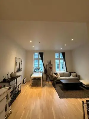 a living room with a couch and a table at Moderne leilighet midt i hjertet av Bergen Sentrum in Bergen