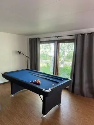 a blue pool table in a room with a window at Hytte Elvdal in Nymoen