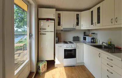 a white kitchen with a refrigerator and a sink at 1 Bedroom Stunning Home In Haugesund in Haugesund