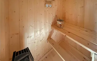 a wooden sauna with a bucket on a shelf at 4 Bedroom Awesome Home In Engerdal in Nymoen