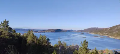 a large body of water with mountains in the background at Matthias Hytte in Fevåg