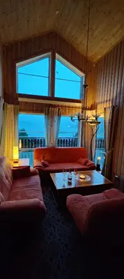 a living room with two couches and a table at Matthias Hytte in Fevåg