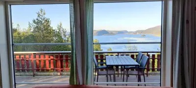 a view of a table and chairs from a window at Matthias Hytte in Fevåg