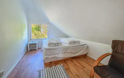a small bedroom with a bed and a window at Awesome Home In Sveio With Wifi in Sveio
