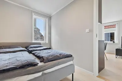 a bedroom with a bed and a window at Exclusive Bergen Suite in Bergen