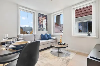 a living room with a couch and a table at Exclusive Bergen Suite in Bergen
