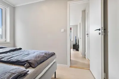 a bedroom with a bed and a hallway at Exclusive Bergen Suite in Bergen