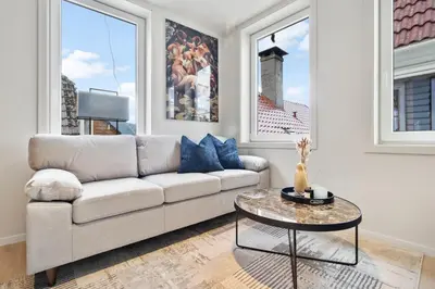 a living room with a couch and a table at Exclusive Bergen Suite in Bergen