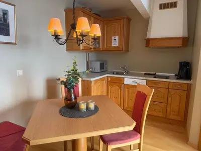 a kitchen with a wooden table with a vase on it at Family-Friendly Apartment Close To Nature in Beitostøl