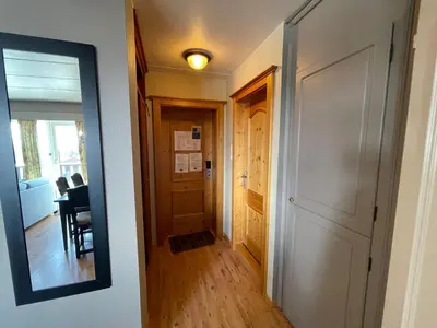 a hallway with a door and a mirror at Central Apartment With 3 Bedrooms And Balcony in Beitostøl