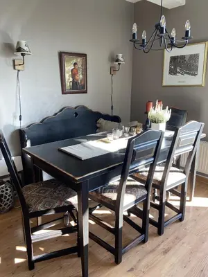 a black dining room table with chairs and a couch at Central Apartment With 3 Bedrooms And Balcony in Beitostøl