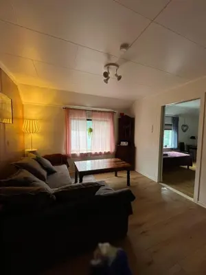 a living room with a couch and a table at Gulthus in Odda