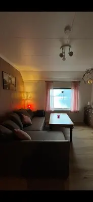 a living room with a couch and a table at Gulthus in Odda