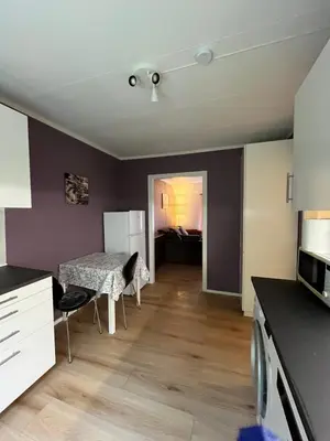 a kitchen and living room with a table and chairs at Gulthus in Odda
