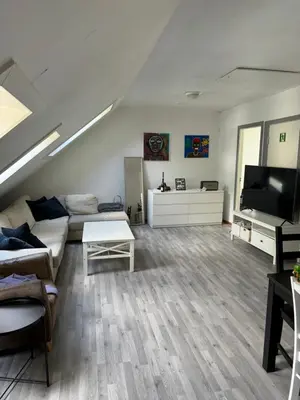 a living room with a couch and a flat screen tv at Spacious and central apartment I 250m from Bryggen in Bergen