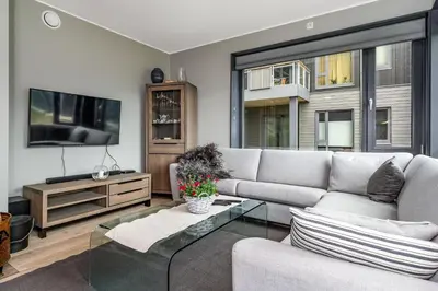a living room with a couch and a tv at Mountain appartment in Sjusjøen