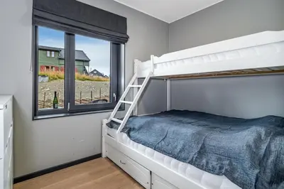 a bedroom with a bunk bed and a window at Mountain appartment in Sjusjøen