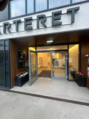 a entrance to a store with a sign on it at Moderne Leilighet in Stord