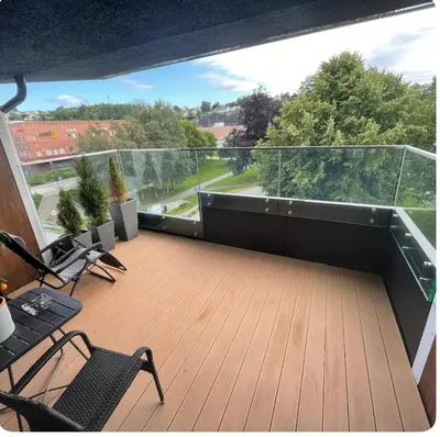 a balcony with chairs and a large view of theenery at Moderne Leilighet in Stord