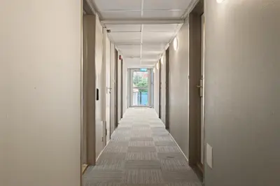 an empty hallway with a long hallway with a corridorngthngthngthngthngthngth at BUDGETEL- Kong Oscarsgate 44 in Bergen