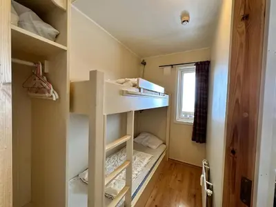 a small room with bunk beds and a window at Family-Friendly Apartment Steps From Everything in Beitostøl