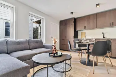 a living room with a couch and a table at Premium Bergen Suite in Bergen