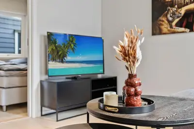 a living room with a tv and a coffee table at Premium Bergen Suite in Bergen