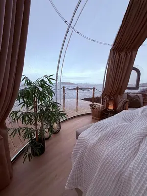 a bedroom with a bed and a view of the ocean at Atlantic Dome in Skotten