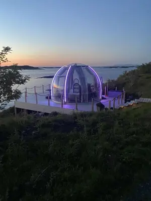 a tent sitting on a dock in the water at Atlantic Dome in Skotten