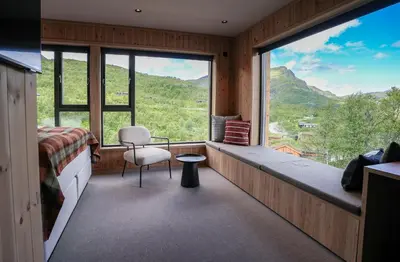 a bedroom with a bed and a large window at Filefjellstuene Hotel in Tyinkrysset