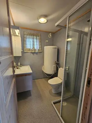 a small bathroom with a toilet and a sink at Øen Hytter 1 in Sørbø