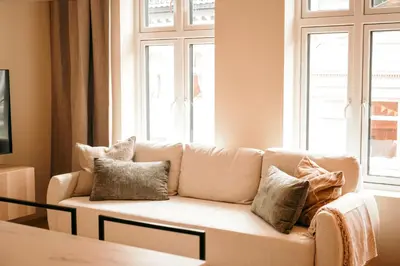 a living room with a couch with pillows on it at Bergen City Apartment in Bergen