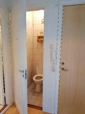 a bathroom with a toilet and a white door at Leilighet nær Trondheim in Trondheim