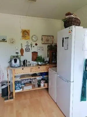 a kitchen with a white refrigerator and a wooden floor at Leilighet nær Trondheim in Trondheim