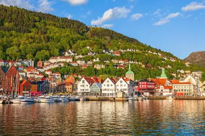 a town on the shore of a body of water with boats at Celestial Bergen Central Apartment in Bergen