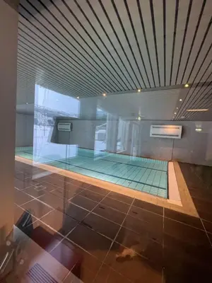 a swimming pool with a glass floor in a building at Voss-Oppheim Resort appartment witc acess to swimmingpool in Øyjordi