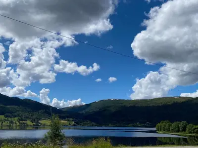 a view of a lake with mountains in the background at Voss-Oppheim Resort appartment witc acess to swimmingpool in Øyjordi