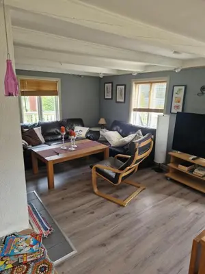 a living room with a couch and a table at Åsenfjord, feriehus ved sjøen in Hopla
